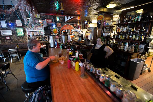 Marnie Bell-Ferguson, left, talks with bartender Jessica Woody at Pallookaville Fine Foods, Monday, Dec. 14, 2015, in Avondale Estates. BRANDEN CAMP/SPECIAL