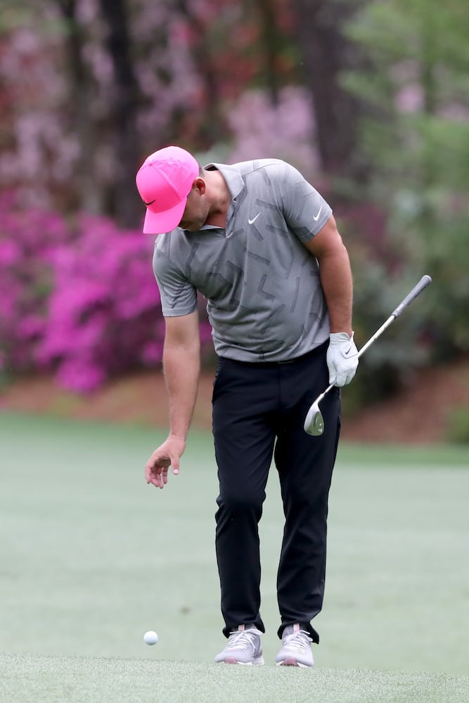 April 8, 2021, Augusta: Brooks Koepka takes a drop after hitting into the tributary to Rae’s Creek on the thirteenth hole during the first round of the Masters at Augusta National Golf Club on Thursday, April 8, 2021, in Augusta. Curtis Compton/ccompton@ajc.com