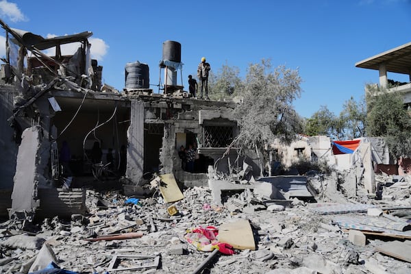 Palestinians inspect their damaged house following an Israeli bombardment in Deir al-Balah, Gaza Strip on Wednesday, March 19, 2025. (AP Photo/Abdel Kareem Hana)