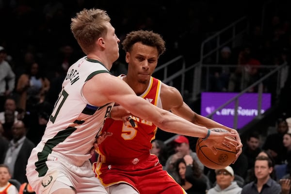 Atlanta Hawks guard Dyson Daniels (5) dribbles the ball in the first half of an NBA basketball game against the Milwaukee Bucks, Tuesday, March 4, 2025, in Atlanta. (AP Photo/Brynn Anderson)