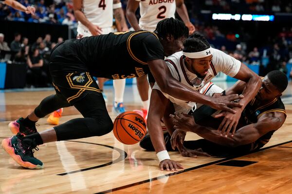 Auburn forward Chaney Johnson (31) and Alabama State center Ubong Okon (35) chase a loose ball during the first half in the first round of the NCAA college basketball tournament, Thursday, March 20, 2025, in Lexington, Ky. (AP Photo/Brynn Anderson)