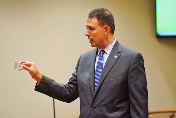 DeKalb County prosecutor Pete Johnson holds up a shell casing for the jury during day three of the Robert Olson murder trial at the DeKalb County Courthouse on October 1, 2019 in Decatur. Olsen is charged with murdering war veteran Anthony Hill. (Elijah Nouvelage for The Atlanta Journal Constitution)