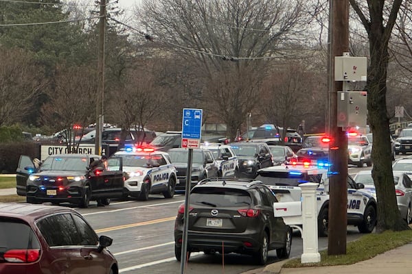 Emergency vehicles are parked outside the Abundant Life Christian School in Madison, Wis., where multiple injuries were reported following a shooting, Monday, Dec. 16, 2024. (AP Photo/Kathleen Foody)