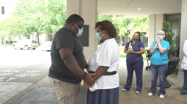 Kim Sloan, an intensive care nurse at Phoebe Putney Memorial Hospital, develped a special bond with patient Laconyea Lynn. She made sure to be there when Lynn left the hospital to go home. Here is Lynn, hugging her son, Victor Hilson. Sloan is in the background.Lynn said she continues to get better and looks forward to going back to work as a caregiver for an elderly couple during the coming weeks. She and her son are also planning a fishing trip.CONTRIBUTED