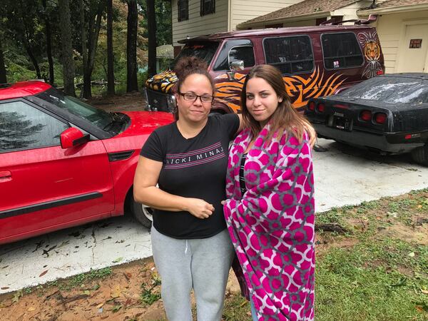 Tamara Felizola, left, and Sara Rodriguez stand outside Felizola's Snellville home Tuesday morning.