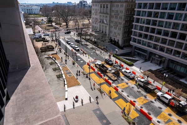 The White House is seen at top left, as demolition begins on the Black Lives Matter mural, Monday, March 10, 2025, in Washington. (AP Photo/Jacquelyn Martin)