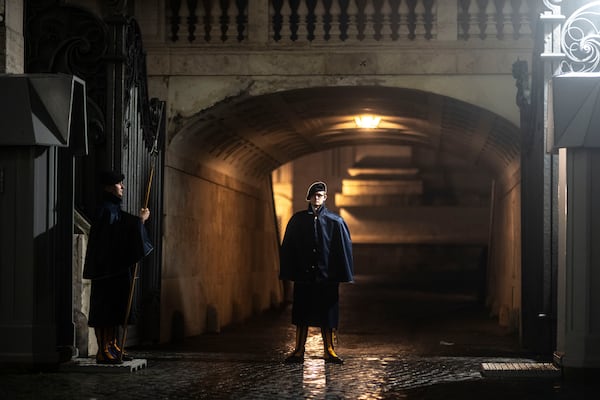 A Swiss Guard patrols one of the Arco Delle Campane, one of the entrances of the Vatican, Monday, Feb. 24, 2025. (AP Photo/Mosa'ab Elshamy)