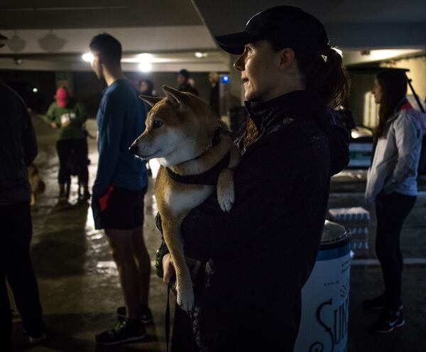 Cassidy Puckett holds her dog Azuki while waiting for the start of the Piedmont Park Conservancy's 5th Year Anniversary of the Doggie Dash in Piedmont Park on Sunday, March  11, 2018.  STEVE SCHAEFER / SPECIAL TO THE AJC