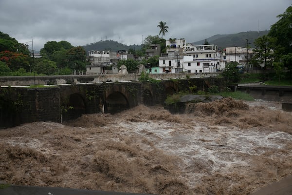 The swollen Los Esclavos River flows violently during Tropical Storm Amanda. Tropical Storm Cristobal, the third-named tropical storm of the Atlantic season, is on a projected path toward the U.S. Gulf Coast, officials said.