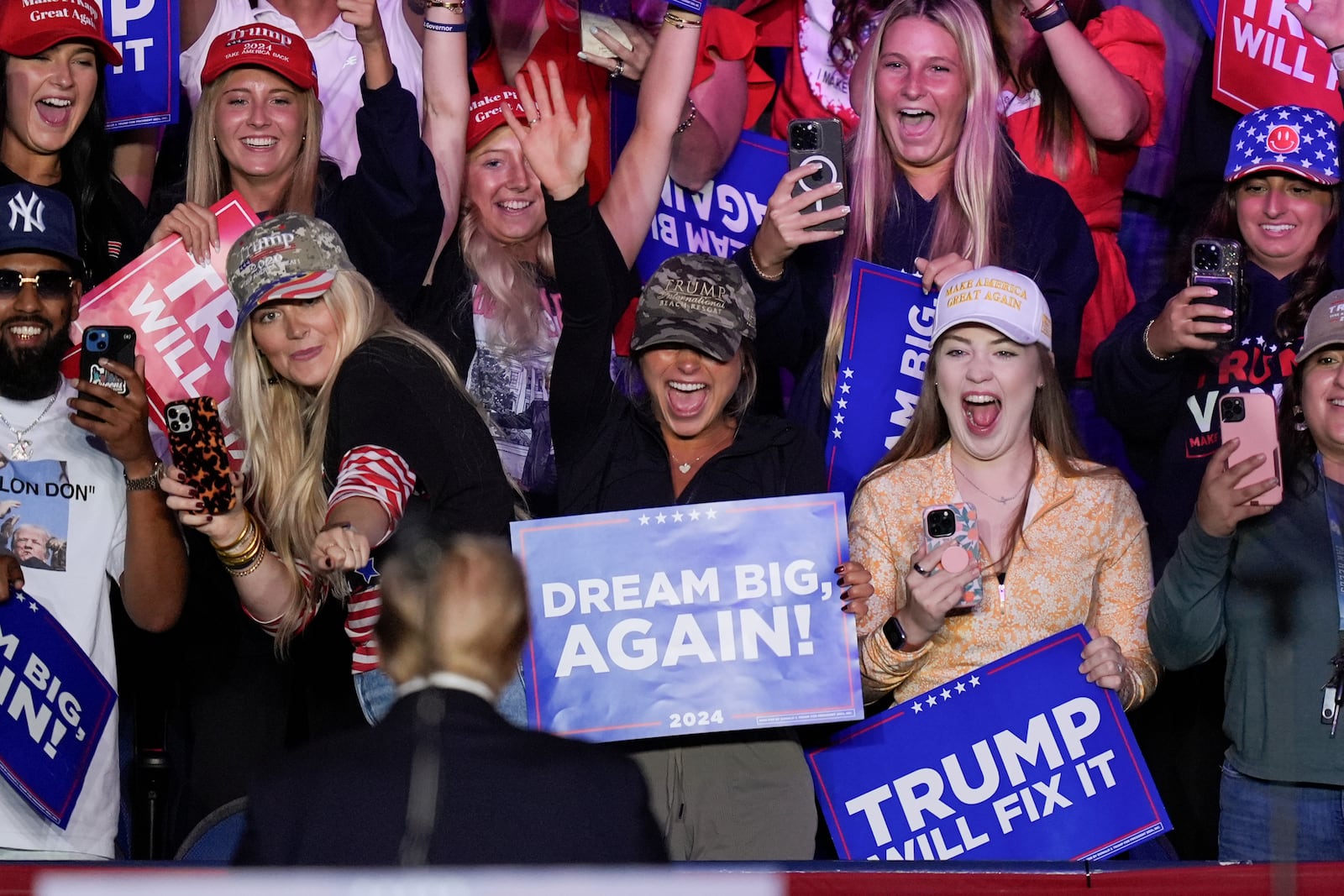 Supporters react to Republican presidential nominee former President Donald Trump as he wraps up a campaign rally at First Horizon Coliseum, Saturday, Nov. 2, 2024, in Greensboro, NC. (AP Photo/Alex Brandon)