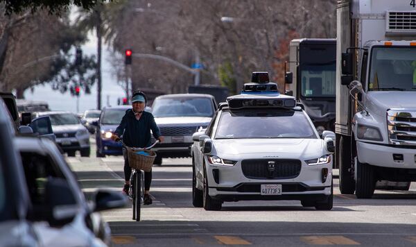 Passengers ride in an electric Jaguar I-Pace car outfitted with Waymo full self-driving technology in Santa Monica, California, Tuesday, Feb. 21, 2023. (Allen J. Schaben/Los Angeles Times/TNS)