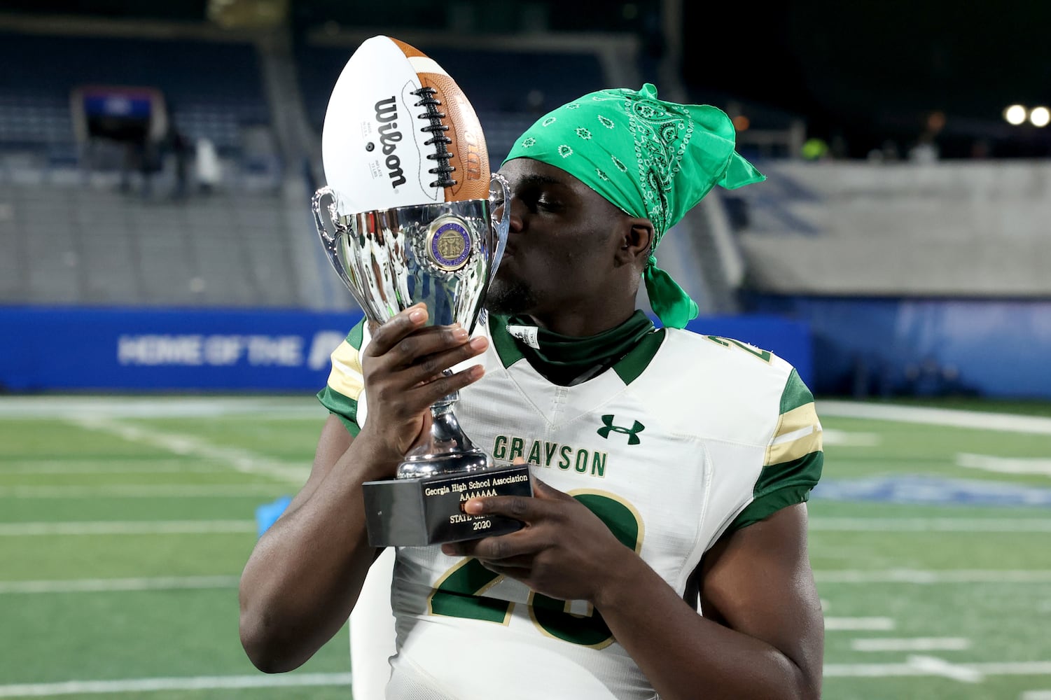 Dec. 30, 2020 - Atlanta, Ga: Grayson running back Phil Mafah kisses the trophy after their 38-14 win against Collins Hill during the Class 7A state high school football final at Center Parc Stadium Wednesday, December 30, 2020 in Atlanta. JASON GETZ FOR THE ATLANTA JOURNAL-CONSTITUTION