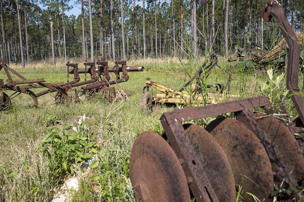 Vintage farm equipment sits at Sedrick Rowe’s farm in Albany. Rowe was getting ready in late April to plant peanuts and watermelon on a 10-acre plot of land. (ALYSSA POINTER/ALYSSA.POINTER@AJC.COM)