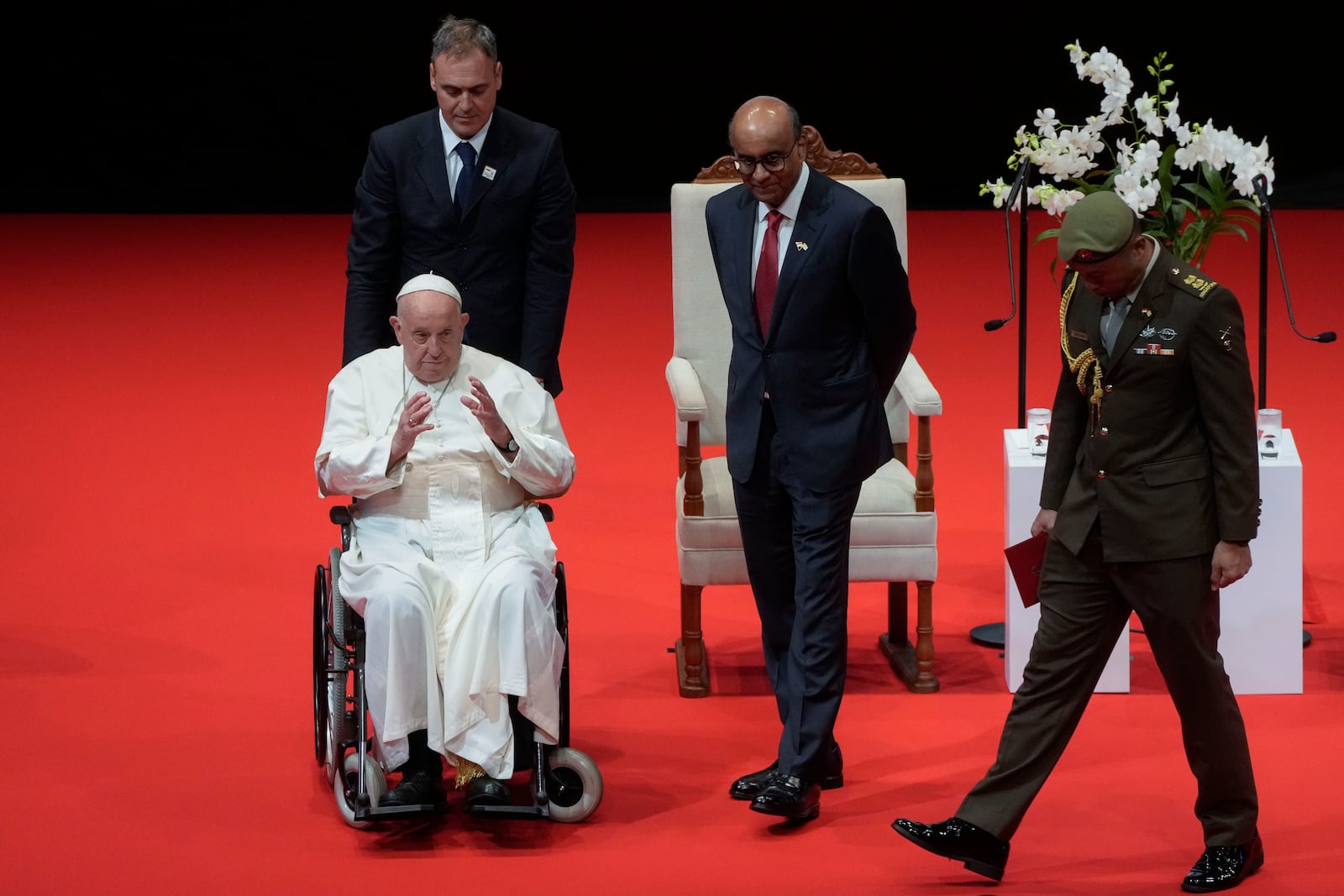 Pope Francis and Singapore's President Tharman Shanmugaratnam, third from left, leave at the end of a meeting with the authorities, civil society and the diplomatic corps in the theatre of the Cultural Centre of the National University of Singapore, Thursday, Sept. 12, 2024. Pope Francis flew to Singapore on Wednesday for the final leg of his trip through Asia, arriving in one of the world's richest countries from one of its poorest after a record-setting final Mass in East Timor. (AP Photo/Gregorio Borgia)