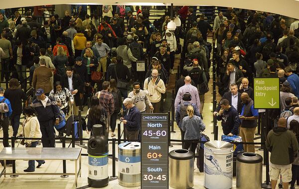 Multiple security lines at Hartsfield-Jackson International Airport ran across the atrium then snaked through baggage claim in both domestic terminals on Monday February 4th, 2019. Official expected over 100,00 travelers to pass through the airport today. (Photo by Phil Skinner)