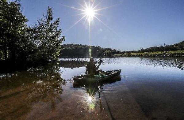 Eddie Scott from Norcross heads out into Stone Mountain Lake on Friday for some fly fishing on a gorgeous June day. 