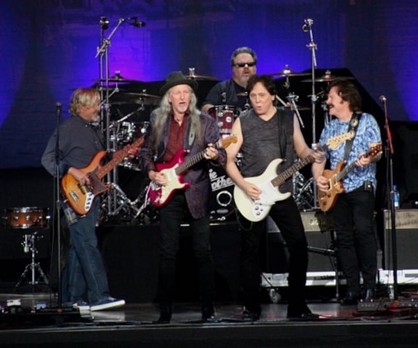  From left - John Cowan, Patrick Simmons, John McFee and Tom Johnston (with drummer Ed Toth) share a moment onstage. Photo: Melissa Ruggieri/AJC