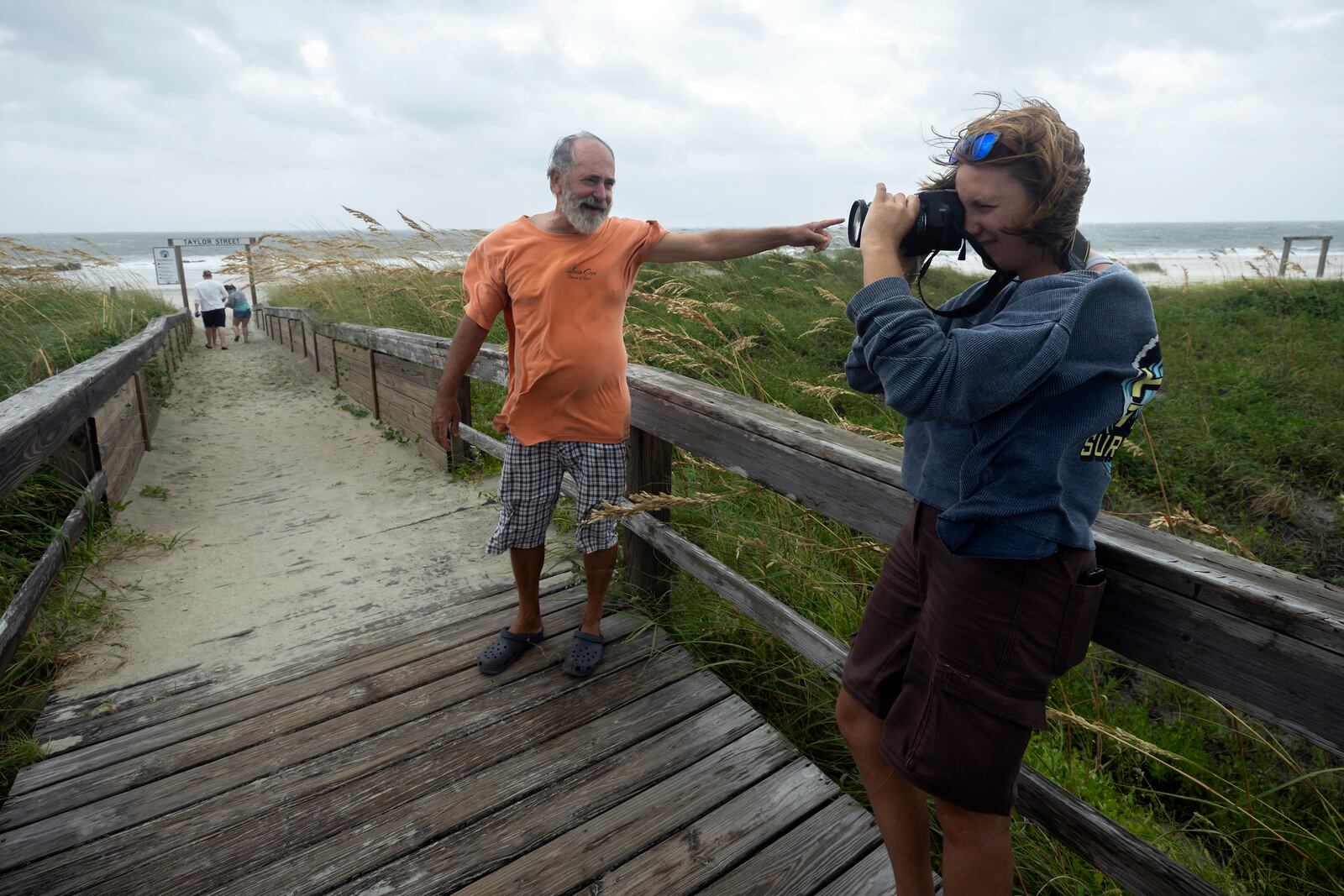 TYBEE ISLAND, GA - AUGUST 30, 2023: 
Abby Bentley, right, and her father Jim Bentley visit the north beach of Tybee Island to see the effects of Hurricane Idalia along the coast, Wednesday, Aug. 30, 2023, in Tybee Island, Ga. The storm made landfall Wednesday in Florida as a Category 3 before sweeping into Georgia. (AJC Photo/Stephen B. Morton)