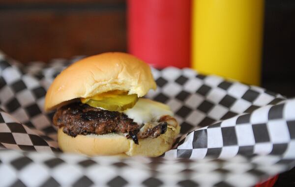 Single cheese --  a 2 oz patty, ground fresh in house, served with American cheese, grilled onions, mustard and pickles -- at Little’s Food Store in Cabbagetown. (BECKY STEIN PHOTOGRAPHY.COM)