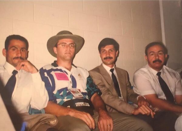 Brian Luders (second from left), an Olympic volunteer, with the tiny Iraqi delegation to the 1996 Games. Weightlifter Raed Ahmed (left) later defected. (Courtesy of Brian Luders)