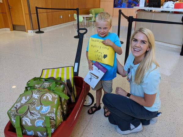 Here’s Levi with Shelbey Fanning, one of his PICU nurses from his hospital stay in 2014. His wagon is full of ice cream sandwiches. 