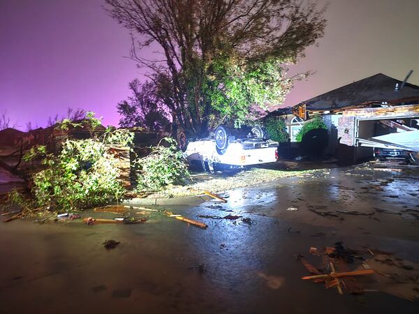 This image provided by Sean Taylor shows a vehicle flipped over near a damaged home after a tornado hit the area in Midwest City, Okla,, Sunday, Nov. 3, 2024. (Sean Taylor via AP)