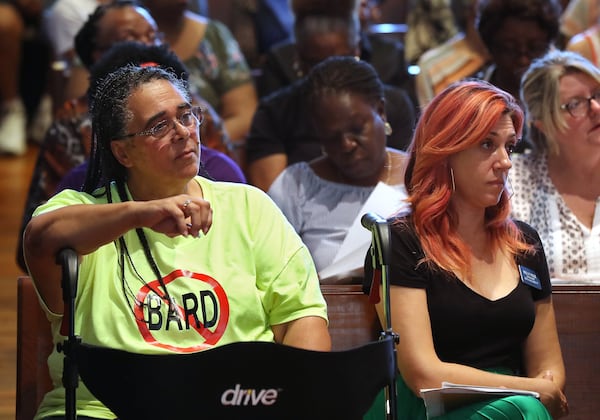 At a town hall Aug. 20, Sonya James (left) and Georgia Senate District 17 candidate Kelly Rose (right), hear from federal and state environmental regulators about emissions of ethylene oxide gas by the nearby Becton Dickinson plant. CURTIS COMPTON / CCOMPTON@AJC.COM