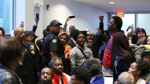 People protest the way the death of 21-year-old Jimmy Atchison was handled by officials at a town hall hosted by Atlanta Mayor Keisha Lance Bottoms at Cascade United Methodist Church in Atlanta on  March 19, 2019. 