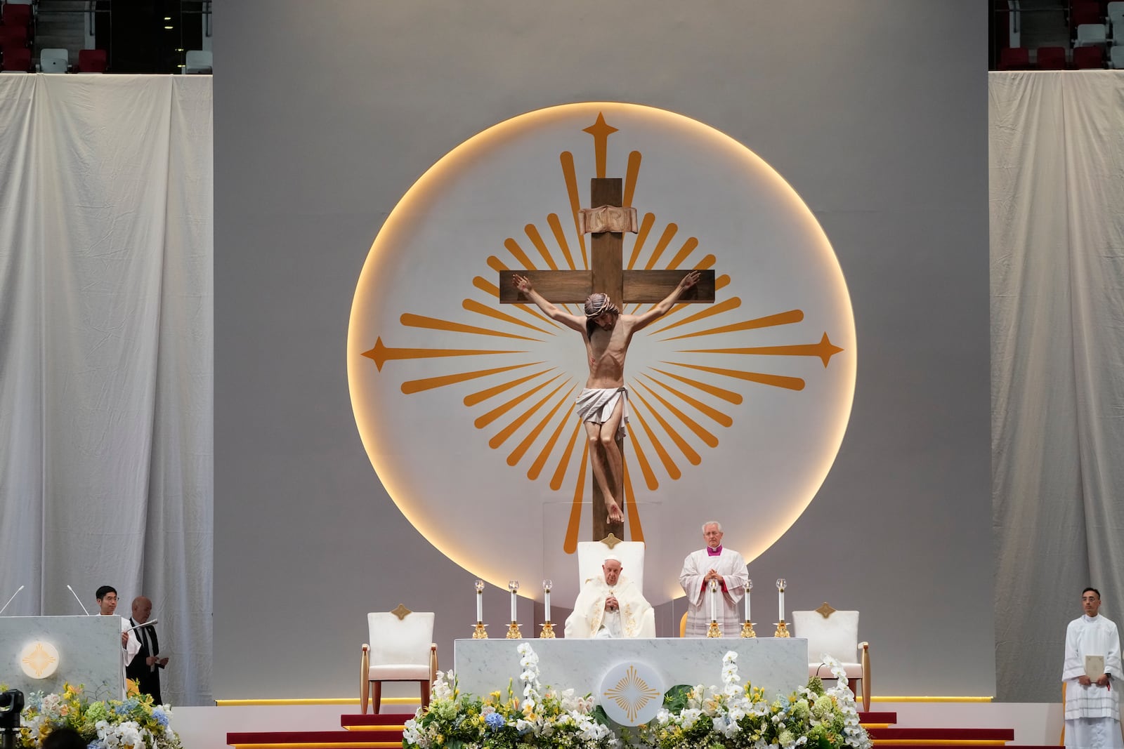 Pope Francis presides over a mass 'In Memory of the Most Holy Name of Mary' celebrated by the Archbishop of Singapore, Cardinal William Goh Seng Chye at the Singapore SportsHub National Stadium, Thursday, Sept. 12, 2024. Pope Francis has praised Singapore's economic development as a testament to human ingenuity. But he's urging the city-state to look after the weakest too. Francis made the remarks Thursday on the final leg of the longest and farthest tour of his papacy. (AP Photo/Gregorio Borgia)