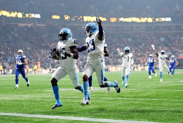 Toronto Argonauts' Robert Priester (19) scores a touchdown after an interception against the Winnipeg Blue Bombers with Benjie Franklin (23) during the second half of a CFL football game at the 111th Grey Cup in Vancouver, British Columbia, Sunday, Nov. 17, 2024. (Nathan Denette/The Canadian Press via AP)