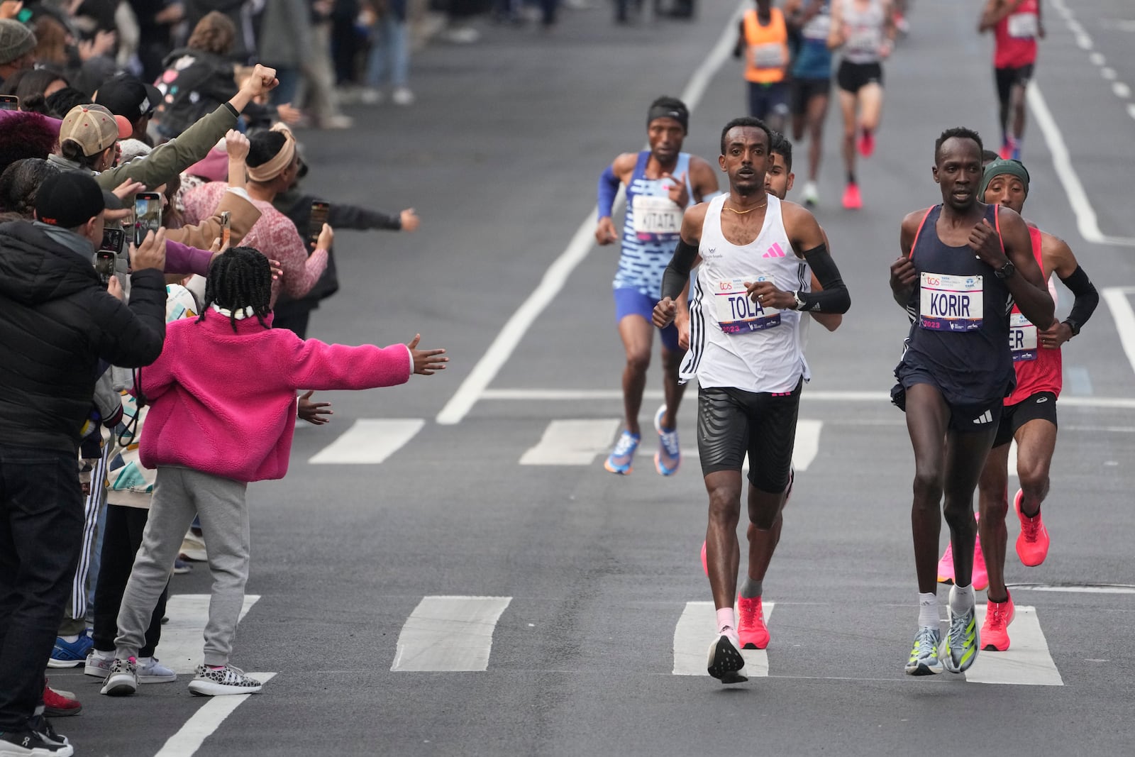 FILE - Tamirat Tola, of Ethiopia, front left, and Albert Korir, of Kenya, front right, lead the pack of elite men runners through Brooklyn during the New York City Marathon in New York, Sunday, Nov. 5, 2023. (AP Photo/Seth Wenig, File)