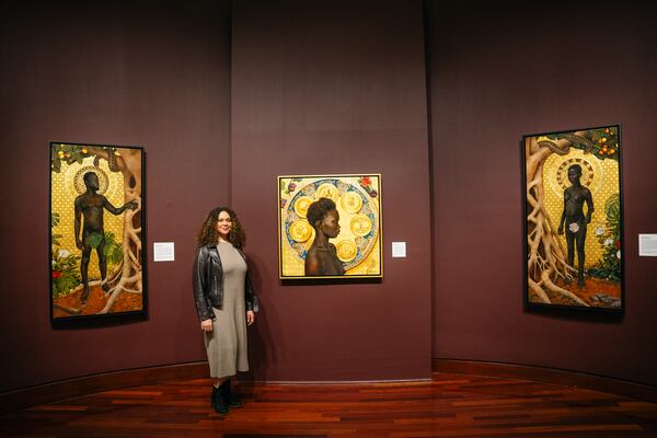 Spelman College Executive Directer of the Museum of Fine Art, Liz Andrews, showcases Afro-Cuban Harmonia Rosales' Master Narrative exhibit on display though November in Atlanta, Georgia on Tuesday, Nov. 28, 2023. (Olivia Bowdoin for the Atlanta Journal-Constitution).  