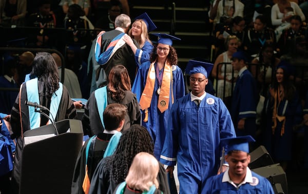 Campbell High School students in Cobb County walk across the stage to receive their diplomas during graduation at Kennesaw State University Convocation Center on Wednesday, May 24, 2023. (Natrice Miller/AJC) 