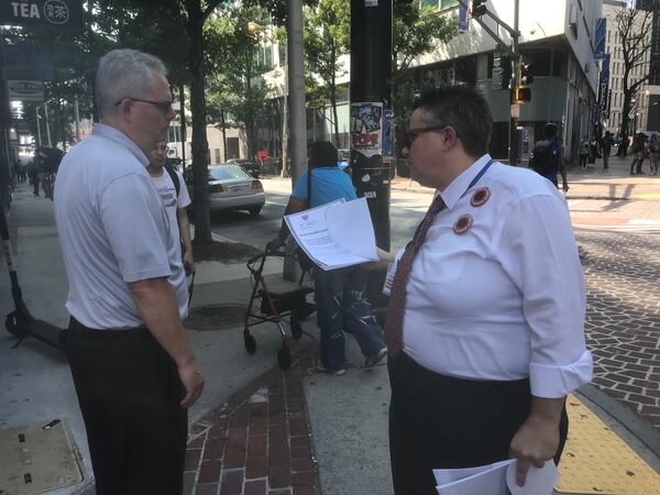 Georgia State University employee Deb Loden talks to another employee about a proposal by United Campus Workers of Georgia to demand the University System of Georgia stop its plan to increase employee health care costs next year. Loden, who's worked nearly 12 years at the university, said the cost increases are more than her raises. "It's going to get to a point where I can't work here anymore," Loden said. ERIC STIRGUS/ESTIRGUS@AJC.COM.