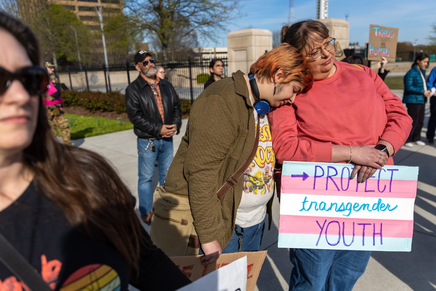 Andy Welch (center) and Andy’s mother Tina Welch lean on each other at a rally against SB 140 outside the Capitol in Atlanta on Monday, March 20, 2023. SB 140 would prevent medical professionals from giving transgender children certain hormones or surgical treatment. (Arvin Temkar / arvin.temkar@ajc.com)