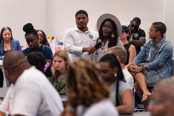 Carver community member Monique Nunnally raises concerns to Bryan Johnson, the sole finalist for superintendent of Atlanta Public Schools, at The New Schools at Carver in Atlanta on Tuesday, June 25, 2024. "We don't feel like there's a lot of equity in our community and that we're getting what we need," she told him. (Seeger Gray / AJC)