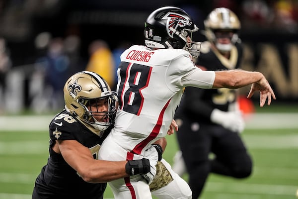 New Orleans Saints defensive end Payton Turner (98) pressures Atlanta Falcons quarterback Kirk Cousins (18) during the first half of an NFL football game, Sunday, Nov. 10, 2024, in New Orleans. (AP Photo/Gerald Herbert)