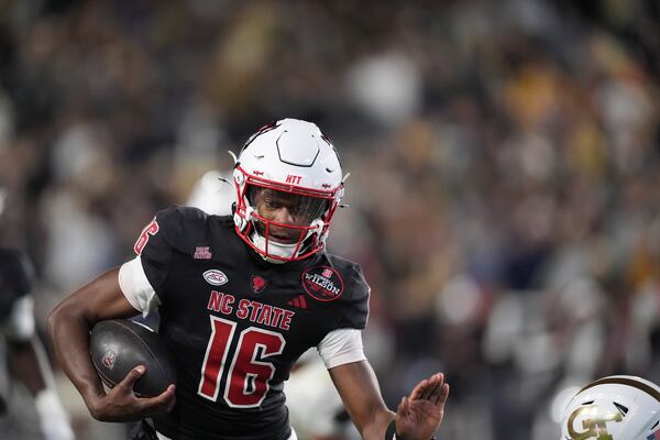 North Carolina State quarterback CJ Bailey (16) runs the ball in for a touchdown during the first half of an NCAA college football game against Georgia Tech, Thursday, Nov. 21, 2024, in Atlanta. (AP Photo/Brynn Anderson)