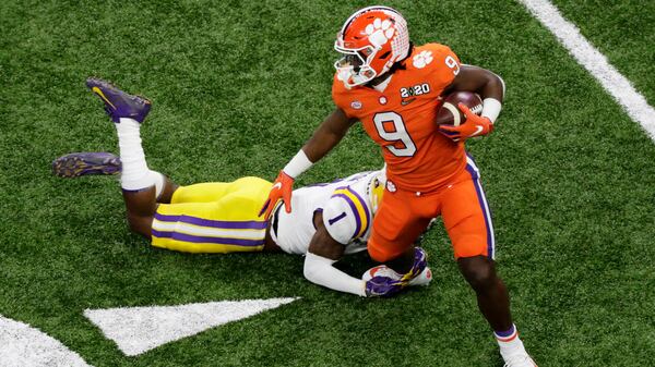 Clemson running back Travis Etienne is tackled by LSU cornerback Kristian Fulton during the first half. (AP Photo/Eric Gay)