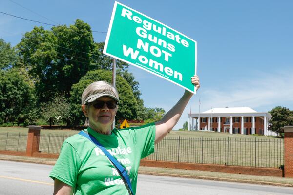 Carol Baird holds up a sign that reads Regulate Guns Not Women across from the Governor’s mansion on Thursday, May 4, 2023, the day after a deadly shooting at a Northside Hospital medical building in Midtown Atlanta.  “There’s not a better day to go to the Governer’s mansion after what happened yesterday.” (Natrice Miller/natrice.miller@ajc.com)