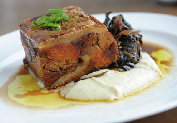 Cochon - roasted shoulder, belly and skin of Heritage Pork, balsamic braised greens, cornbread puree au jus at Southern Gentleman in Buckhead Atlanta. (BECKY STEIN PHOTOGRAPHY.COM)