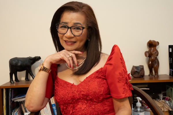 Jane Rolen poses in traditional Filipiniana in her home in East Point, Georgia on Monday, Nov. 20, 2023. Outside of her normal 9-5 job, Jane organizes several events for Filipino American History Month each October and serves as President of Philippine American Chamber of Commerce Georgia (PACCGA). She also hosts a podcast catering to Filipinos living in Georgia, one of the largest AAPI communities. (Olivia Bowdoin for the Atlanta-Journal Constitution).