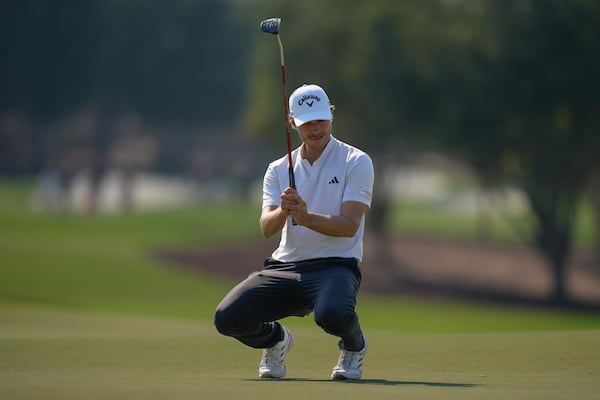 Rasmus Højgaard of Denmark reacts after missing a shot on the 9th green in the final round of World Tour Golf Championship in Dubai, United Arab Emirates, Sunday, Nov. 17, 2024. (AP Photo/Altaf Qadri)