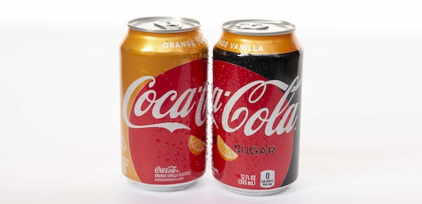 In this image provided by the Atlanta-based Coca-Cola Co.,  the new flavors Orange Vanilla Coke and Orange Vanilla Coke Zero Sugar are  shown. The beverages hit stores Feb. 25.