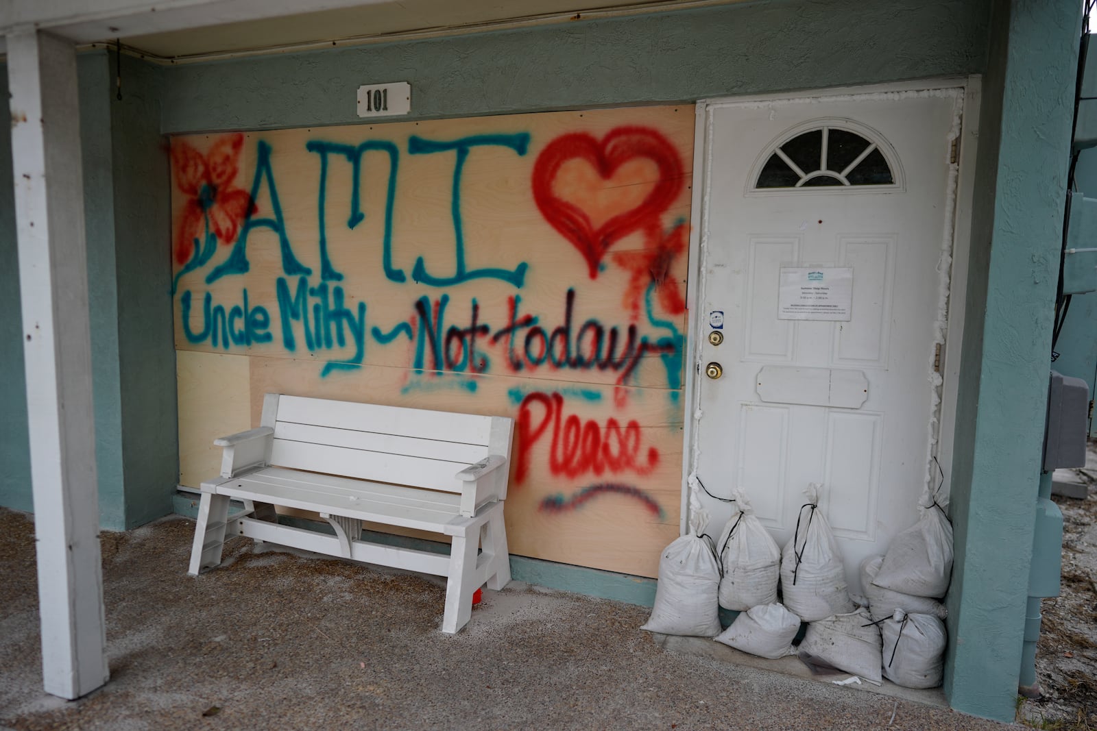 Boards on the window of a store display a message ahead of the arrival of Hurricane Milton, in Bradenton Beach on Anna Maria Island, Fla., Tuesday, Oct. 8, 2024. (AP Photo/Rebecca Blackwell)