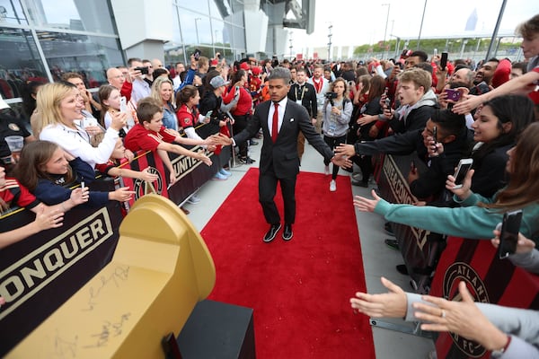  Atlanta United forward Josef Martinez greets fans as he approaches the giant golden spike outside Mercedes-Benz Stadium on April 7, 2018 in Atlanta Ga.