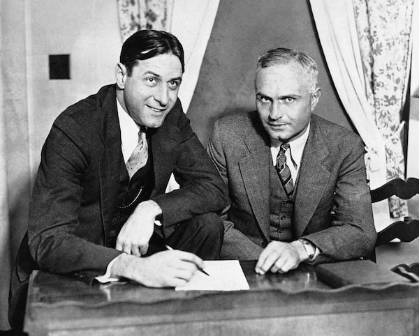 Bernie Bierman, former Minnesota football star, right, talking over his new job with Fritz Crisler during stopover in Chicago on Dec. 7, 1931. Bierman  who has coached Tulane's team to its high rating this year, will coach the football team of his alma mater next season. Crisler, who has coached the Minnesota Gophers the last two years, will devote full time to his duties as athletic director. (AP Photo)