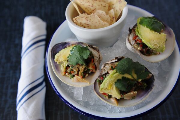 Hog Clams lightly steamed tossed in lime juice, olive oil, pickled onions, scallions, Thai chiles, sweet red bell pepper, avocado and cilantro, served with taro root chips. (BECKYSTEIN.COM)