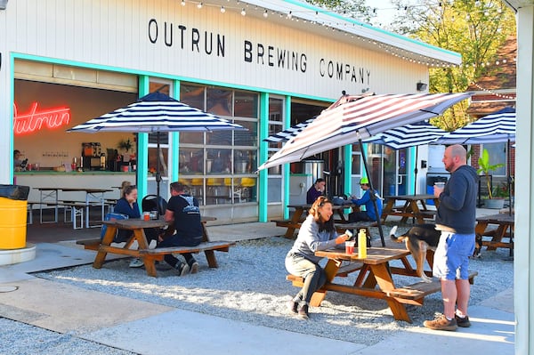 Patrons enjoy a cool late Sunday afternoon recently at Outrun Brewing Co. in Stone Mountain Village. (Chris Hunt for The Atlanta Journal-Constitution)