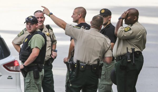 Douglas County deputies gather at Lithia Springs High School after a teacher shot himself inside the school Thursday morning. Classes were canceled but scheduled to resume Friday. Few details about the shooting were available Thursday evening. JOHN SPINK/JSPINK@AJC.COM